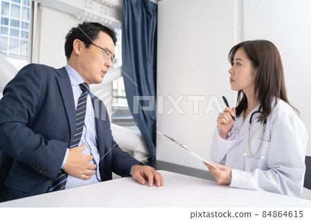 Image of female doctor and male patient with stomach pain 84864615