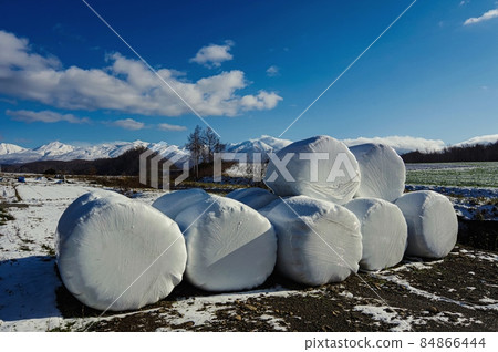 Snow-covered Tokachidake mountain range and roll veil wrap silo (Kamifurano, Hokkaido) Snow-covered Tokachidake mountain range and roll veil wrap silo (Kamifurano, Hokkaido) 84866444