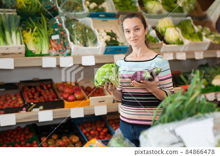 Female choosing fresh broccoli Female choosing fresh broccoli 84866478