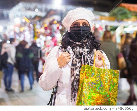 Latin woman in mask at christmas fair Latin woman in mask at christmas fair 84866503
