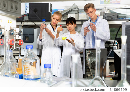 Group of European and Chinese scientists posing together at biochemical laboratory 84866599