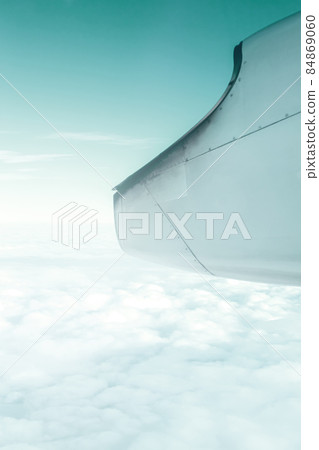 A wonderful view from the window of an airplane: Green sky and sunshine 84869060