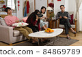 chinese family feeling bored and neglecting each other while playing with phone. virtual reality device and video game in the living at home during chinese lunar new year holiday 84869789