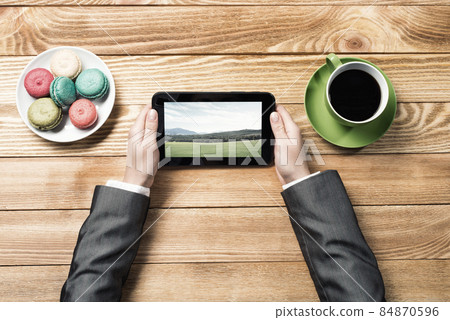Businesswoman having coffee break Businesswoman having coffee break 84870596