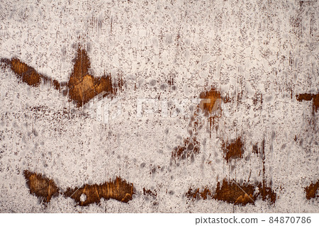 Aged mahogany countertop with cracked and frayed white paint 84870786