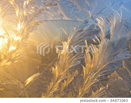 Ice pattern and sunlight close up on window glass early in the morning 84871063