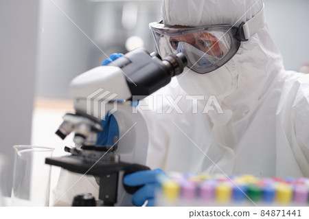 A man in looks through an X-ray microscope A man in looks through an X-ray microscope 84871441