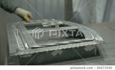 Forge workshop on table. Smithy manual production. Work on the product. Ruler, angle grinder. The blacksmith manufacture of fireplaces, stoves. 84872040