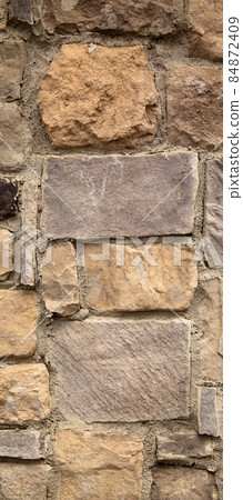 Sturdy yellow and beige cut stone wall, seamless lined up 84872409