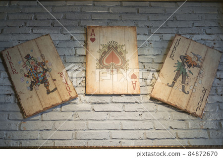 Cafe design. Playing cards on the wall in a coffee shop. Vintage style. High quality photo Cafe design. Playing cards on the wall in a coffee shop. Vintage style. High quality photo 84872670