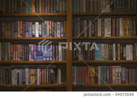 Wooden shelves with books in the cafe. Vintage style in a cafe. Library. High quality photo 84872698