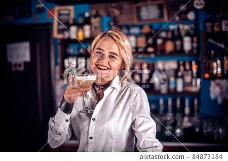 Experienced woman bartending demonstrates his skills over the counter on the bar Experienced woman bartending demonstrates his skills over the counter on the bar 84873184