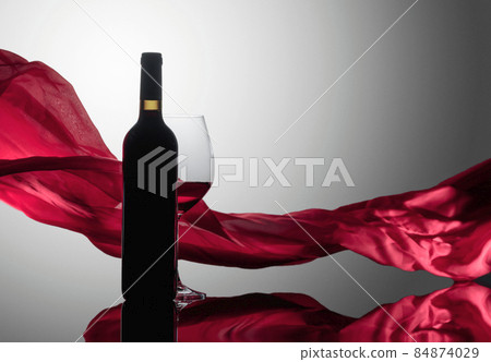 Red wine on a reflective background. 84874029