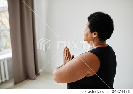 African American Senior Woman doing Yoga Side View African American Senior Woman doing Yoga Side View 84874458