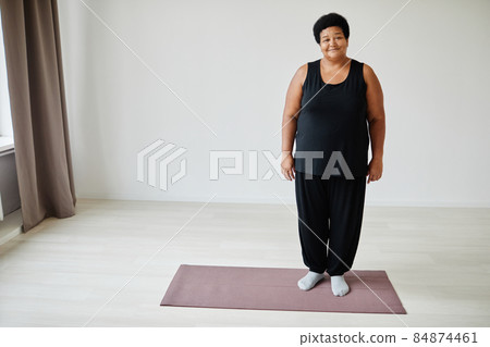 African American Senior Woman Standing on Yoga Mat African American Senior Woman Standing on Yoga Mat 84874461