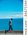A man walking on the sea and the embankment 84875340