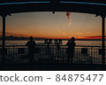 Silhouette of a person watching the sunrise from a ship 84875477