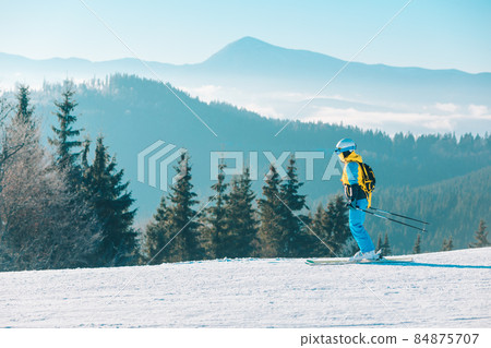 woman skiing down by winter slope 84875707