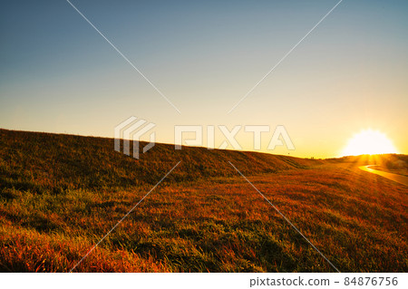 A bank that shines golden in the setting sun 84876756