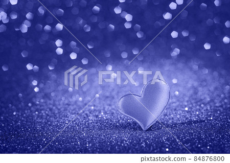 Cute red heart for valentine's day on bokeh background. Trendy color of the year 2022. Greeting card, place for text. 84876800