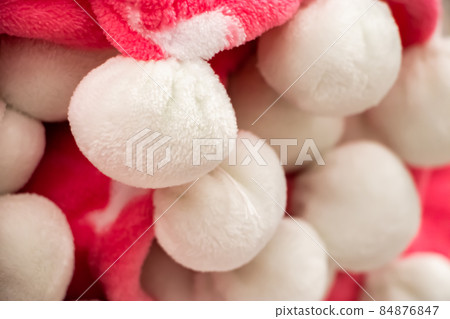 Pink plaid with white pompons. A warm accessory for a cozy autumn. 84876847