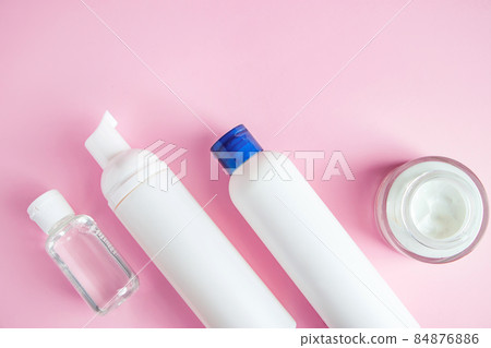 Set of cosmetics for skin care and cleansing on a pink background. The concept of purity and body health. Place for text. 84876886