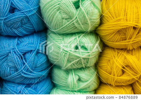 Many balls of wool yarn for knitting. Selling fluffy threads in a craft store. Many balls of wool yarn for knitting. Selling fluffy threads in a craft store. 84876889