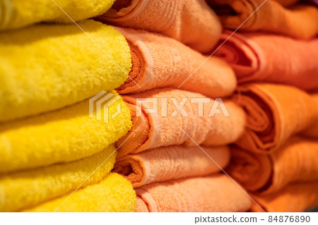A stack of multi-colored bath towels close-up. Spa accessories for health care. A stack of multi-colored bath towels close-up. Spa accessories for health care. 84876890
