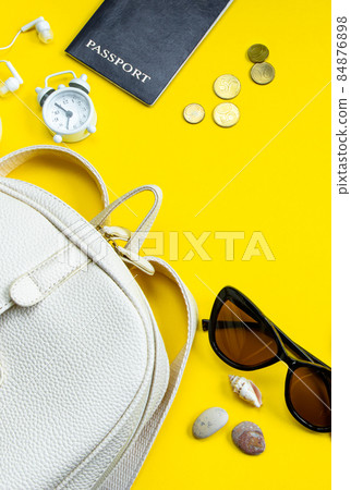 Flatlay accessories for summer vacation. Travel planning. Passport, money, sunglasses on a yellow background. Place for text. Flatlay accessories for summer vacation. Travel planning. Passport, money, sunglasses on a yellow background. Place for text. 84876898