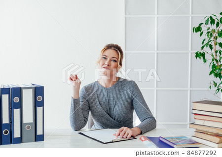 business woman at a desk in the office business woman at a desk in the office 84877292