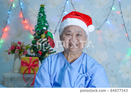 Asian senior or elderly old lady woman patient with Santa Claus helper hat in Christmas and new year celebration festival holiday party in hospital. Asian senior or elderly old lady woman patient with Santa Claus helper hat in Christmas and new year celebration festival holiday party in hospital. 84877543