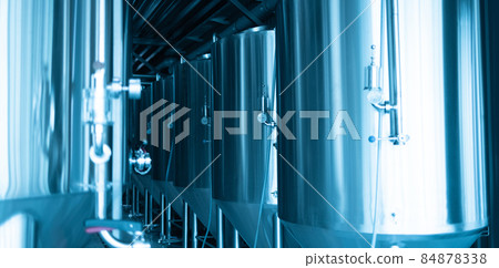 Manometers on steel cylinder storages or vats or tanks on beer and cider production plant, industry machine equipment 84878338