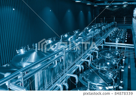 Private microbrewery. Modern beer plant with brewering kettles, tubes and tanks made of stainless steel 84878339