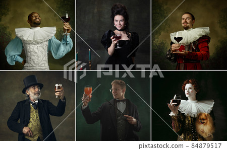 Multi Ethnic people in image of medieval royalty persons in vintage clothing with drinks on dark background. Concept of comparison of eras Multi Ethnic people in image of medieval royalty persons in vintage clothing with drinks on dark background. Concept of comparison of eras 84879517