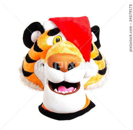 Head of a plush orange tiger in a red santa claus hat on a white background, isolate. Christmas and New Year 2022 concept, close-up Head of a plush orange tiger in a red santa claus hat on a white background, isolate. Christmas and New Year 2022 concept, close-up 84879578