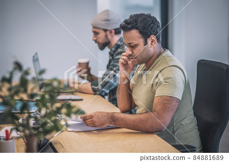 Two guys with laptop and smartphone working in office Two guys with laptop and smartphone working in office 84881689