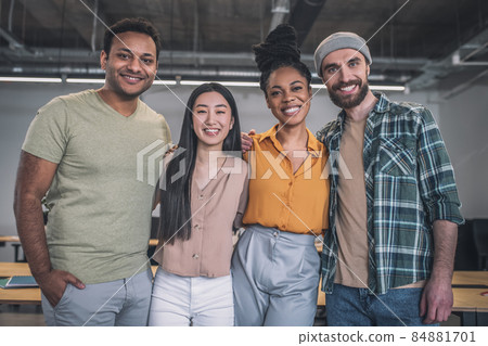 Group of young smiling people looking at camera Group of young smiling people looking at camera 84881701