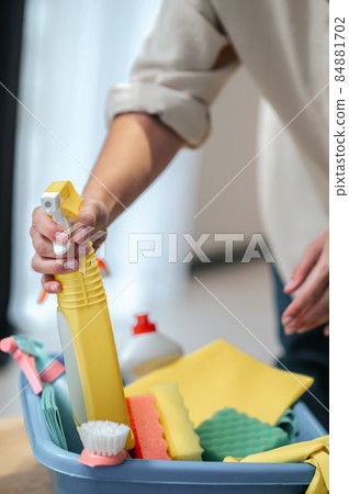 Close up picture of hands taling something from the box with cleaning supplies Close up picture of hands taling something from the box with cleaning supplies 84881702