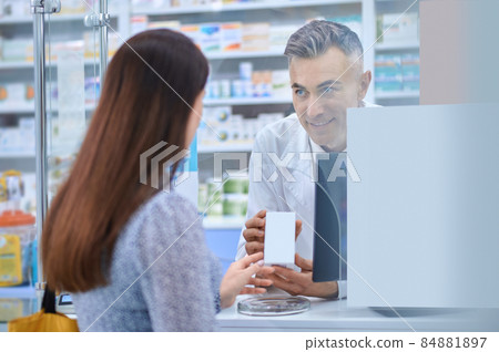 Female client standing near the pharmacy counter 84881897