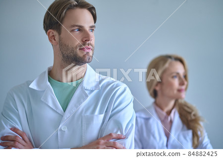 Man thinking looking to side and woman behind 84882425