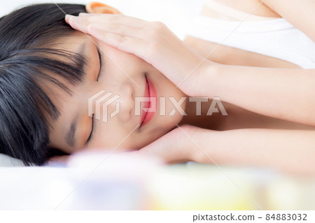 Beautiful of young asian woman smiling and lying on bed at bedroom, beauty of girl touch cheek. Beautiful of young asian woman smiling and lying on bed at bedroom, beauty of girl touch cheek. 84883032