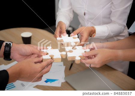 Hands of team young business and partner holding piece jigsaw for assembly is metaphor. Hands of team young business and partner holding piece jigsaw for assembly is metaphor. 84883037