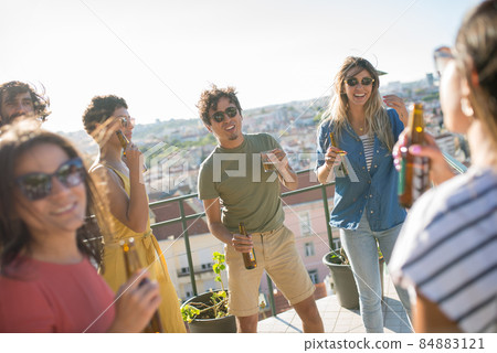 Active friends at terrace roof party on sunny day Active friends at terrace roof party on sunny day 84883121