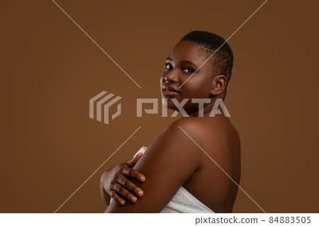 Portrait of beautiful plus size African American woman embracing herself 84883505