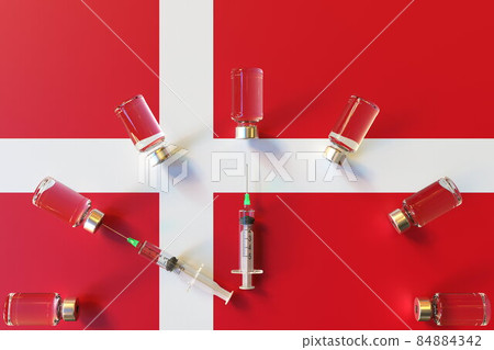 Glass vials and syringes on the flag of Denmark. Vaccination related conceptual 3D rendering Glass vials and syringes on the flag of Denmark. Vaccination related conceptual 3D rendering 84884342