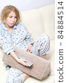 Teenager sitting on couch, watching tv 84884514