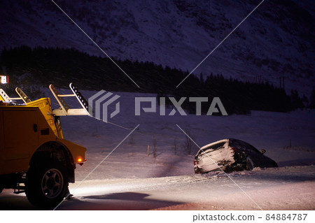 Car being towed after accident in snow storm 84884787