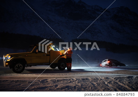 Car being towed after accident in snow storm Car being towed after accident in snow storm 84884793
