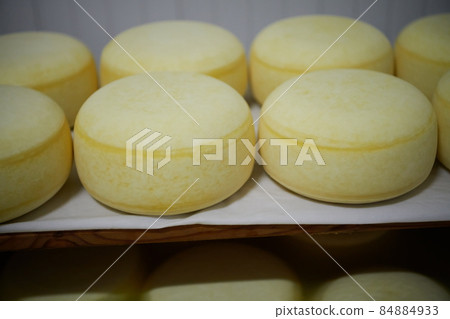 Cheese factory production shelves with aging old cheese Cheese factory production shelves with aging old cheese 84884933
