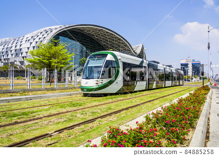 Cityscape of light rail train and the metropolitan building in Kaohsiung, Taiwan. The light rail system in Kaohsiung is the first light rail transit in Taiwan. 84885258